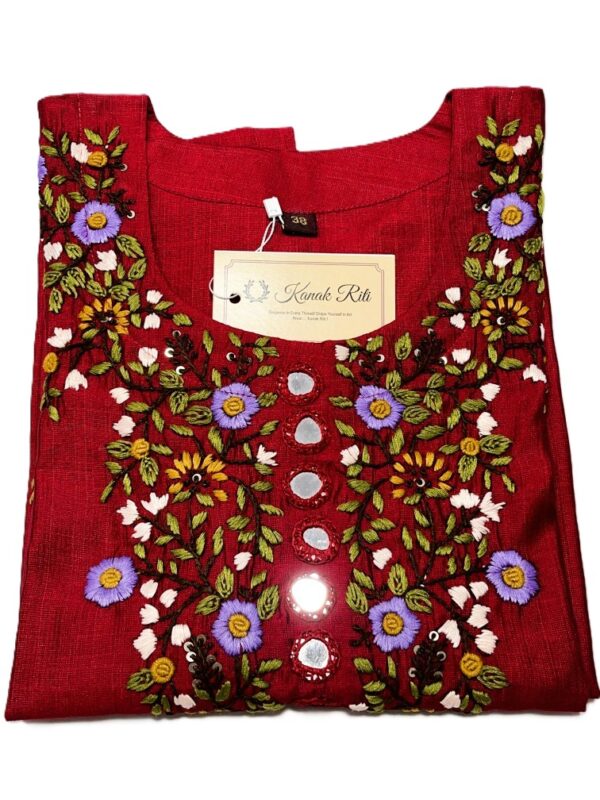 Red embroidered tunic/top with colorful floral embroidery and decorative mirror-like accents, tag attached.